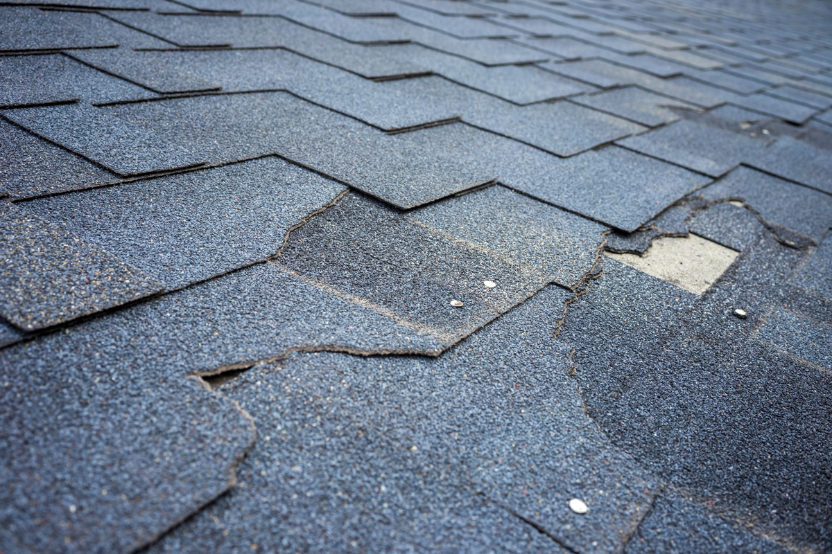 Cracked shingles on a roof in El Paso.